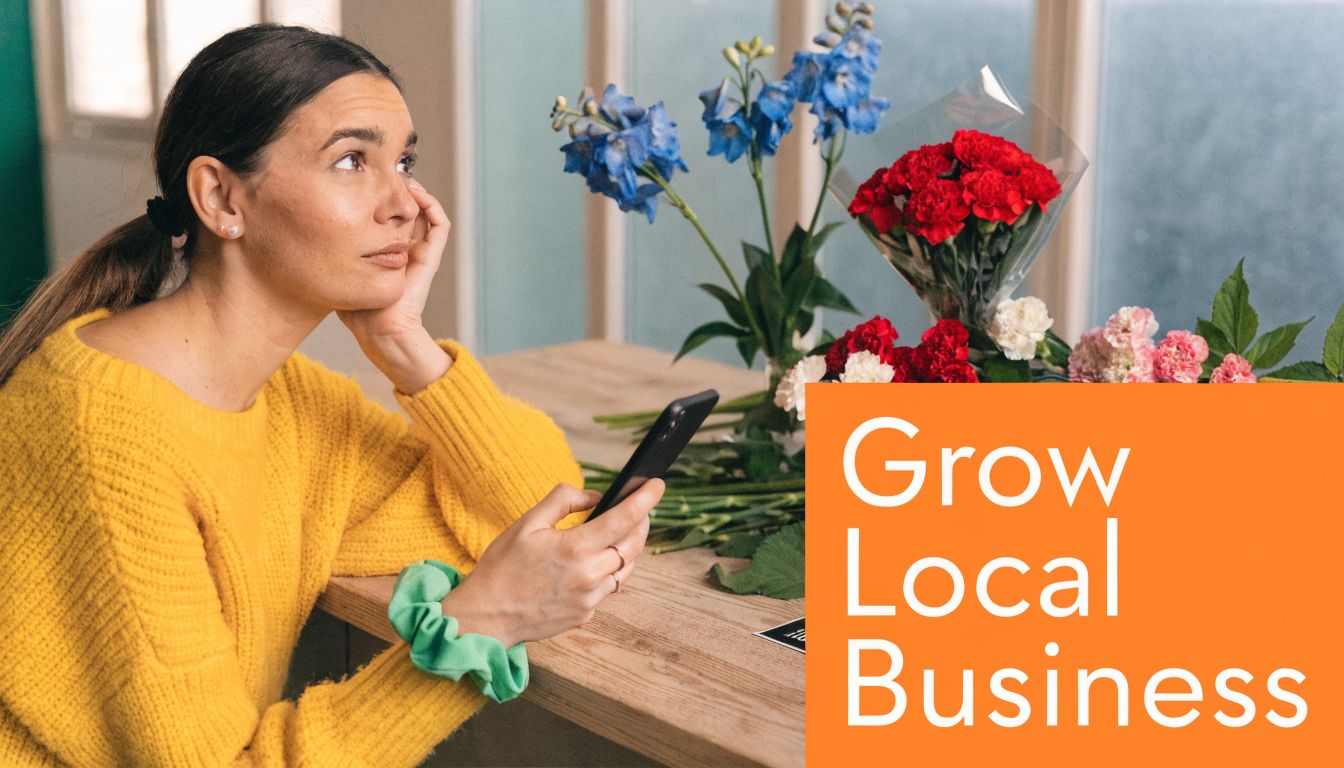 A thoughtful woman in a yellow sweater holding a smartphone beside a display of beautiful fresh flowers